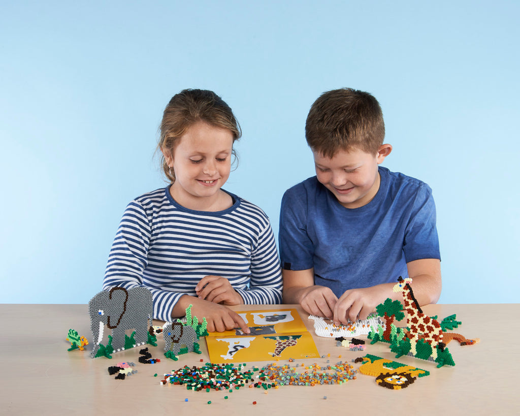 a boy and a girl are playing with legos